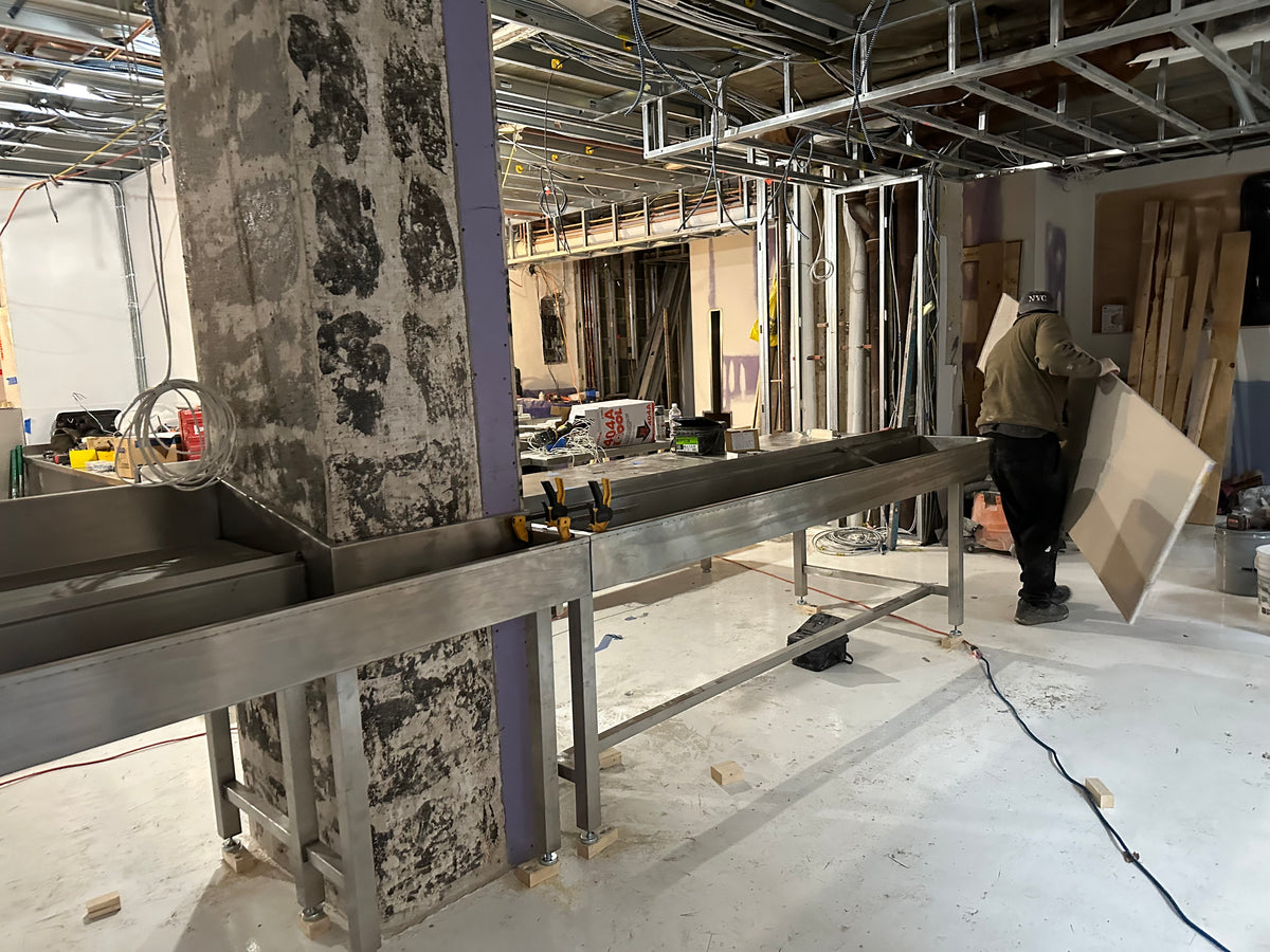 2022: Stainless counter bases with built-in ice chests go in. My contractor and I made ¼" plywood mock-ups first and sent them to the fabricator, so the steel would fit tight around the columns.