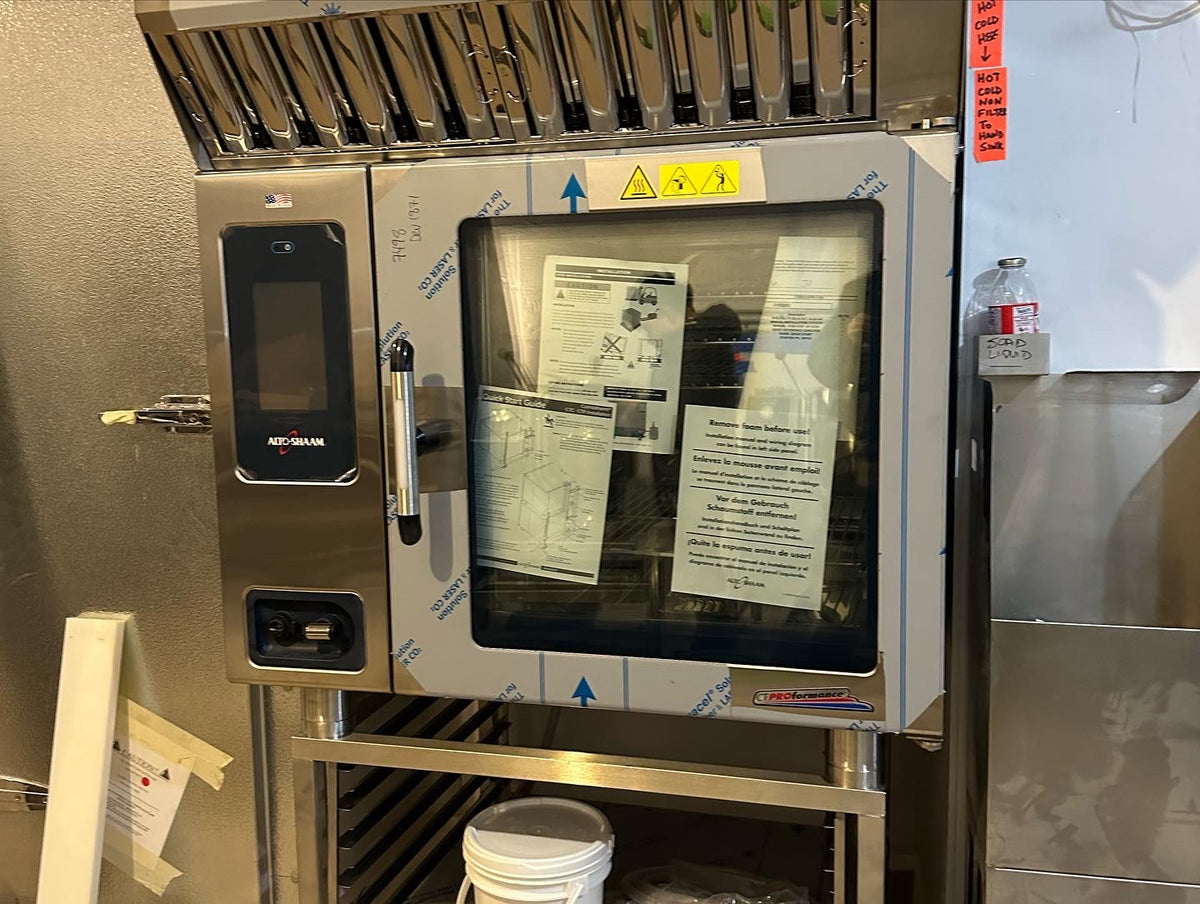 $35,000 Alto-Shaam bakery oven. It works beautifully. The $7K hood above it is useless. Paying for a self-cleaning steam system was a mistake: two cheaper ovens stacked on top of each other would have saved space and doubled our capacity.