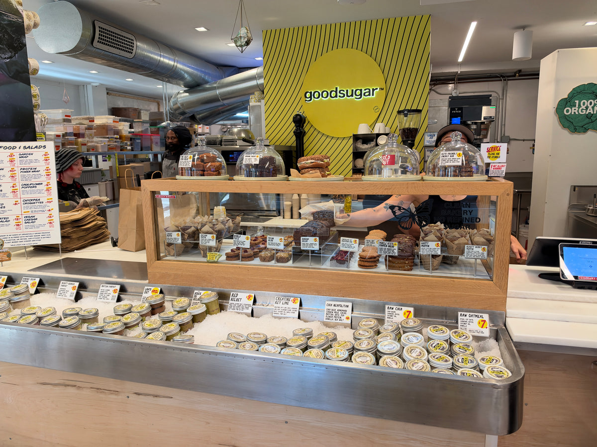 The retail area in 2026, with Naomi behind the bakery counter.